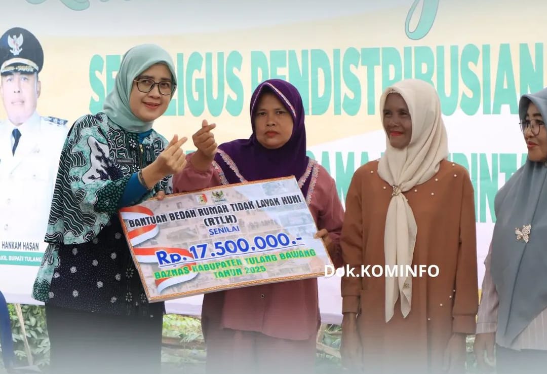 Ketua TP PKK Tulang Bawang, Ibu Herlinawati Qudrotul, S.H., menyerahkan secara simbolis bantuan Bedah Rumah Tidak Layak Huni (RTLH) senilai Rp17.500.000 kepada warga penerima manfaat dalam kegiatan launching program bantuan sosial bersama Baznas Kabupaten Tulang Bawang, Kamis (15/5/2025) di Menggala Selatan.