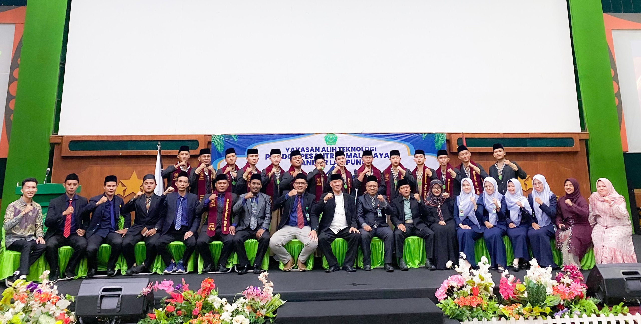 Para wisudawan angkatan pertama Pondok Pesantren Malahayati Bandar Lampung berfoto bersama dewan guru dan tamu kehormatan usai prosesi Haflah Akhirussanah yang digelar di Gedung Graha Bintang Universitas Malahayati, Sabtu (21/6/2025).