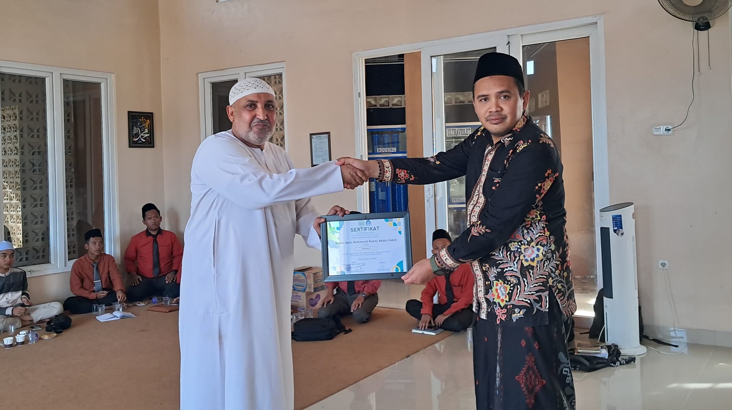 Syekh Amin Mahmoud Ramzy Abdul Halim menerima sertifikat penghargaan dari panitia pelaksana seusai menyampaikan materi dalam kegiatan Dauroh Bahasa Arab yang digelar Rumah Ngaji Bina Cendekia Luhur, Jati Mulyo, Lampung Selatan, Sabtu (19/7/2025).